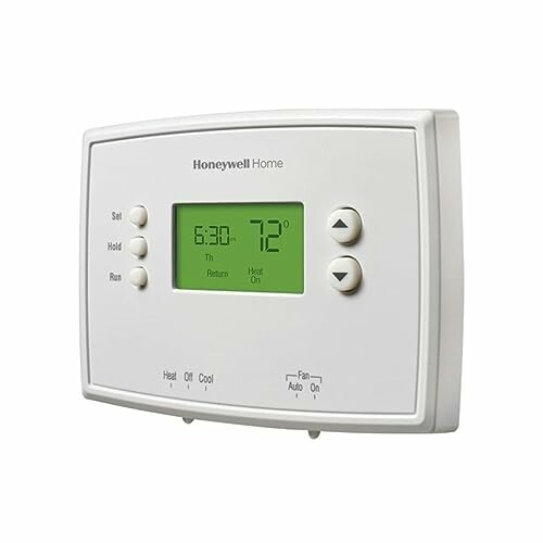 Digital thermostat with display and control buttons.