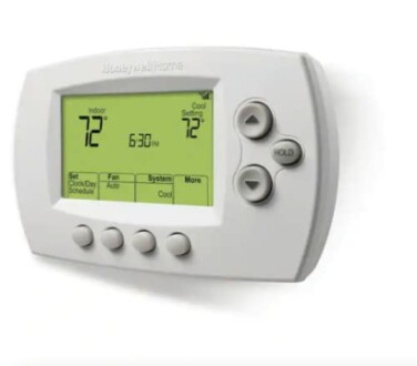 Digital thermostat displaying temperature settings.