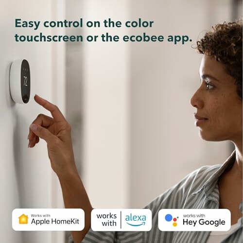 Person adjusting a smart thermostat on the wall.