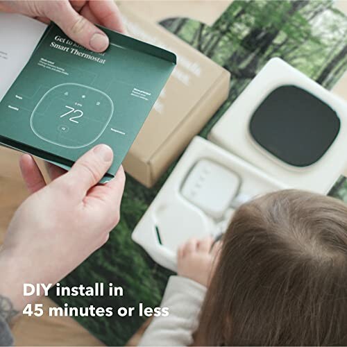 Person holding smart thermostat manual, child with device parts, text 'DIY install in 45 minutes or less'.