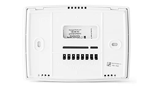 Back view of a thermostat with wiring terminals and labels.