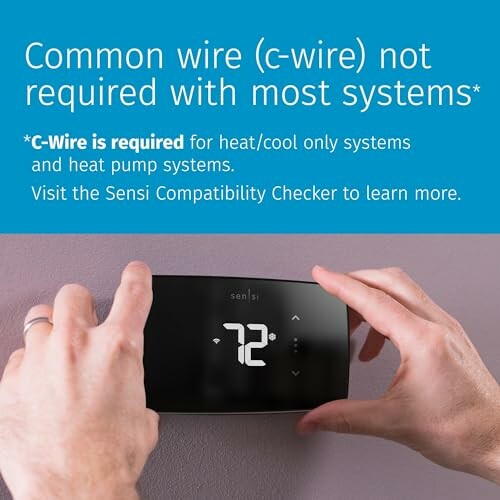Hands adjusting a digital thermostat with c-wire information.
